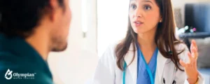 woman doctor speaking with male patient